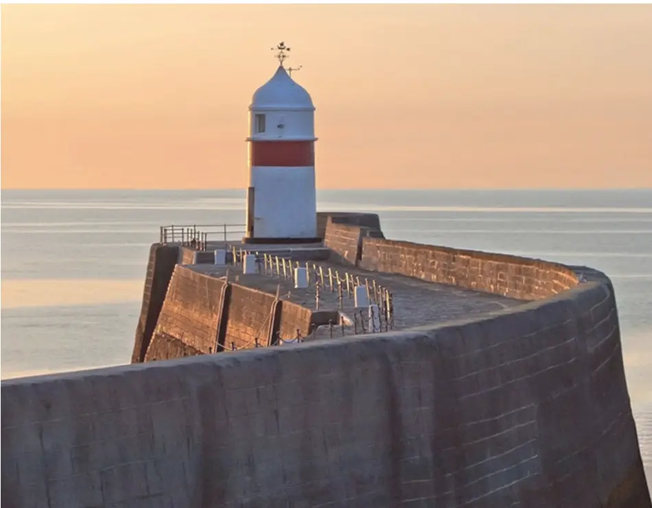 Lighthouse and harbour wall on the Isle of Man